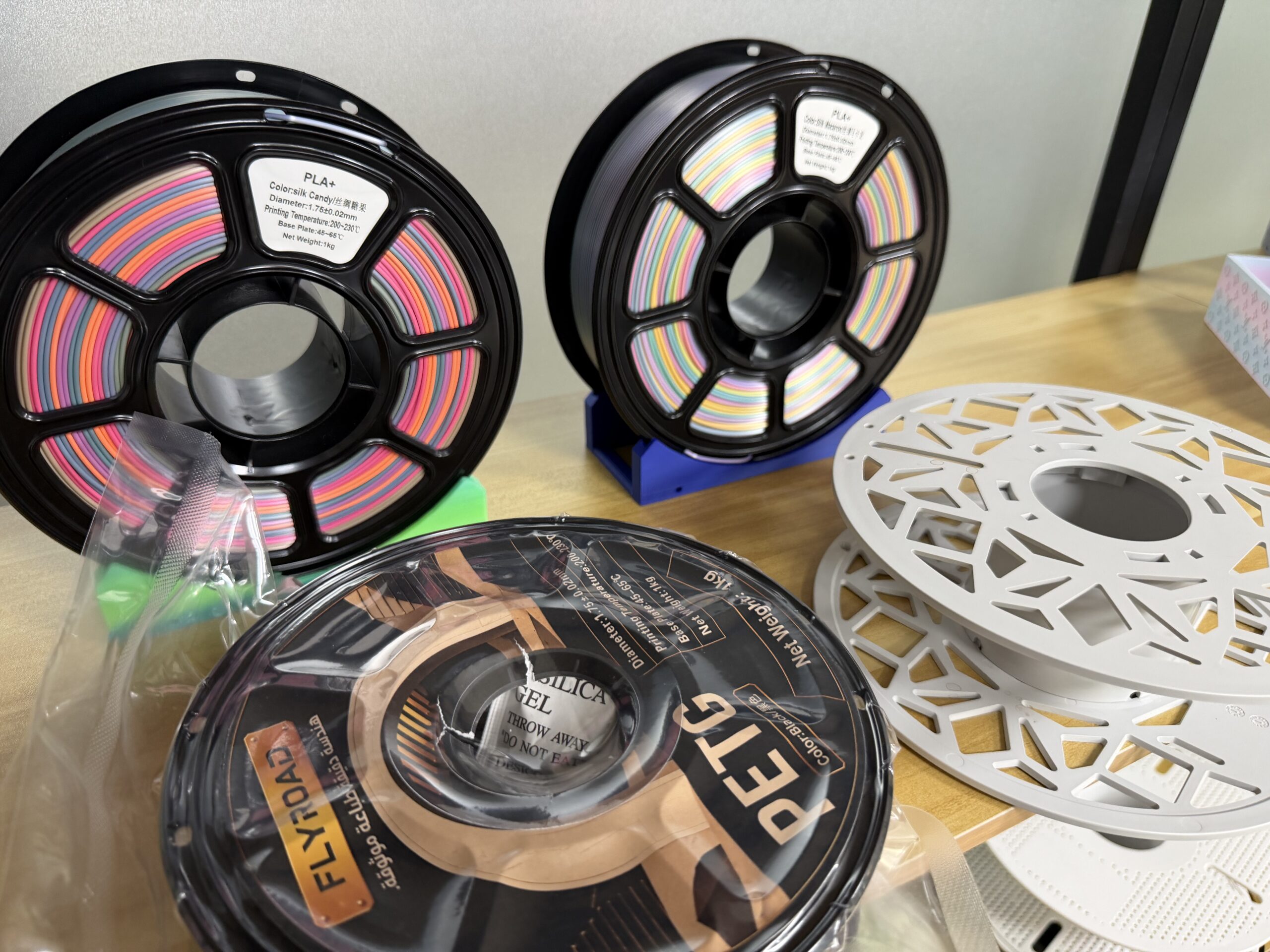 PLA+ filament samples and printed parts arranged for comparison